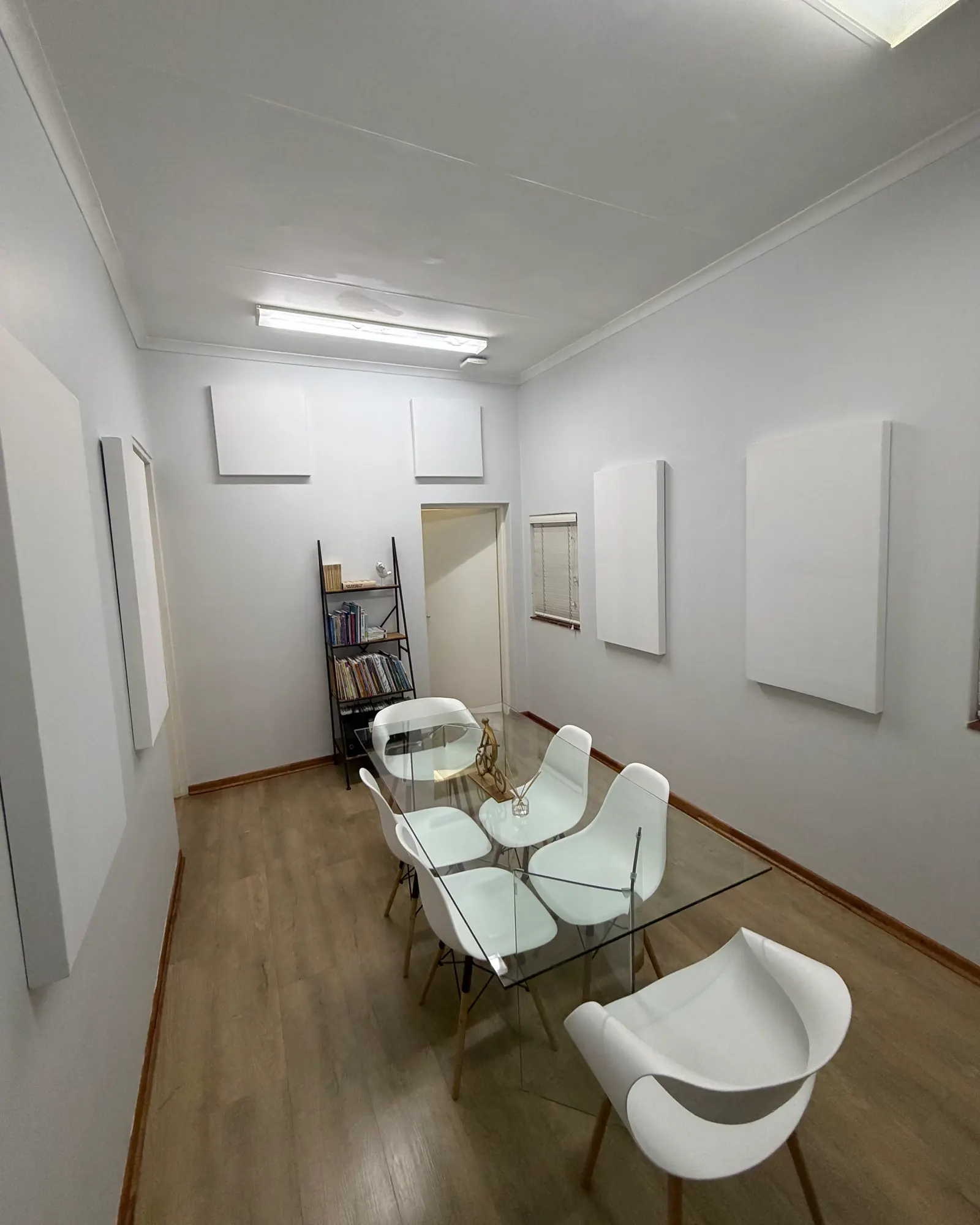 The meeting room from the other end, with square panels high on the far wall and large panels on the side wall