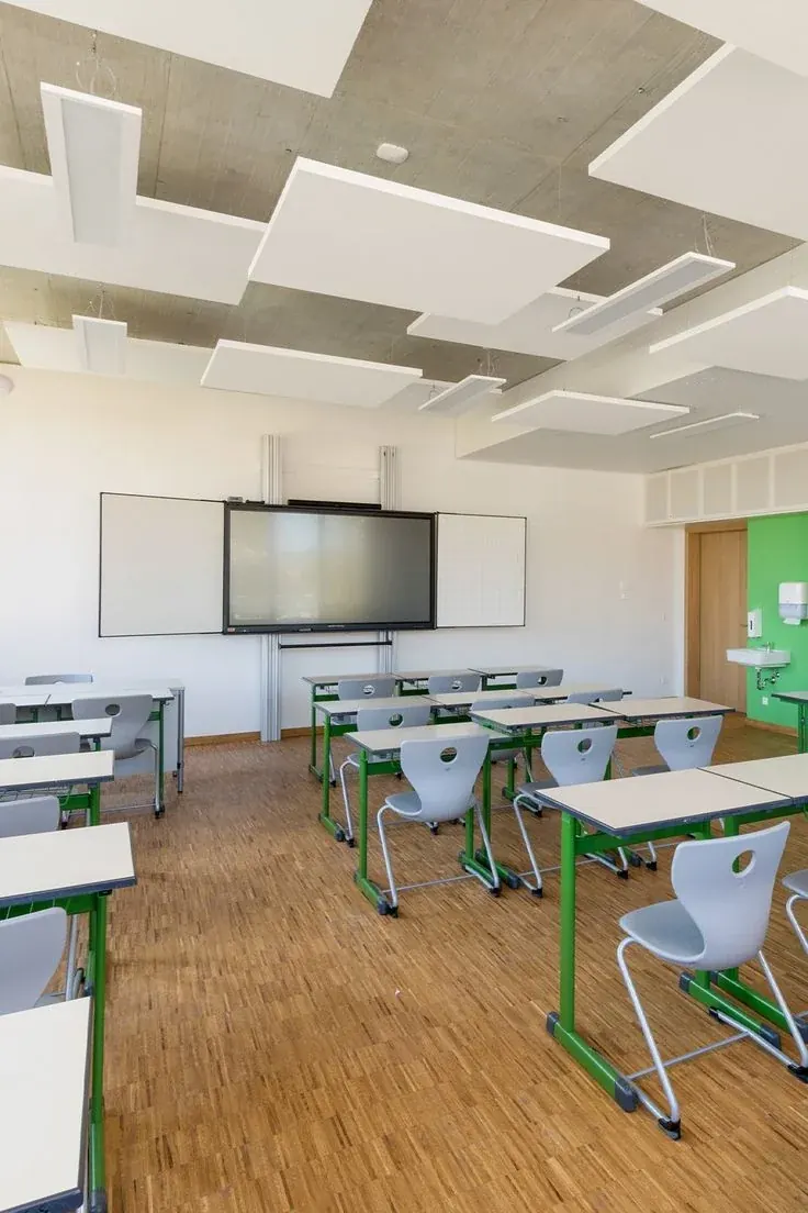 White and grey acoustic panels suspended above a classroom